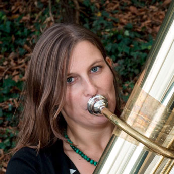 KV Prof. Jörg Wachsmuth, schwarzer Anzug, Zylinder, Brille, umgekehrte Tuba zwischen Beine geklemmt