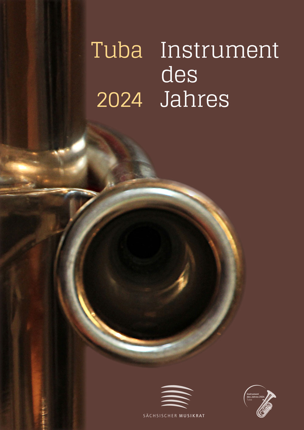 Das Mundstück einer Tuba als Close-Up vor einem bordeauxroten Hintergrund, darüber steht auf dem Bild „Tuba Instrument des Jahres 2024“ geschrieben, darunter ist das Logo des Sächsischen Musikrats (5 weiße Bögen) und das weiße Logo einer Tuba zu sehen.