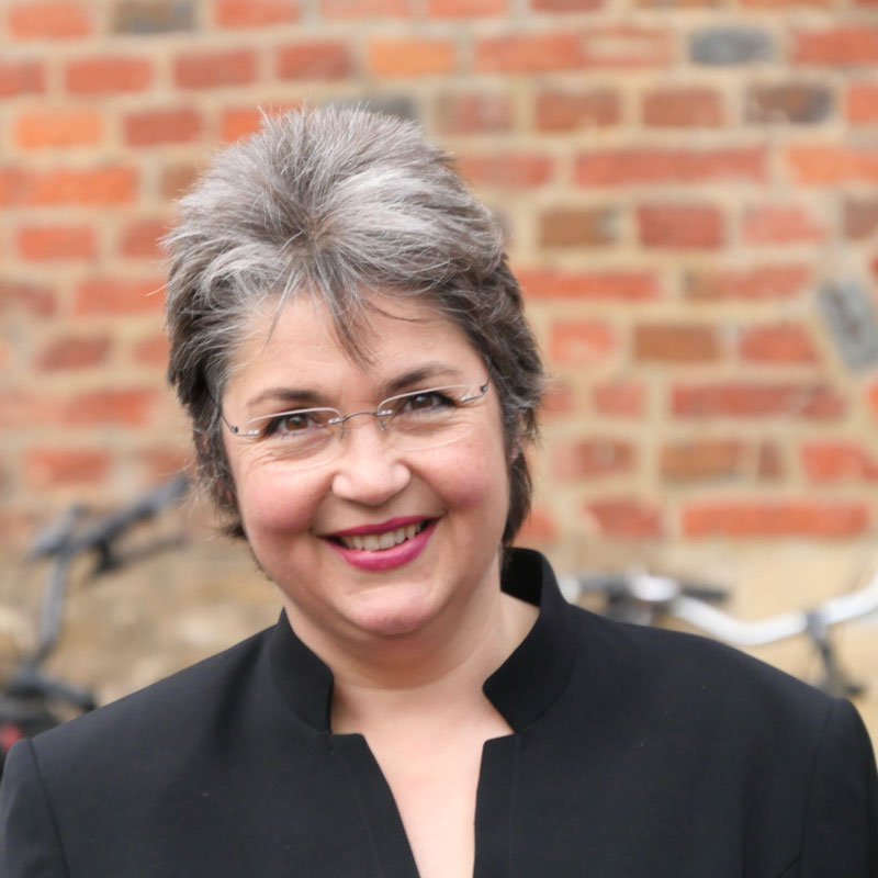 Inga Mareile Reuther, kurze graue Haare, Brille, rot geschminkte Lippen