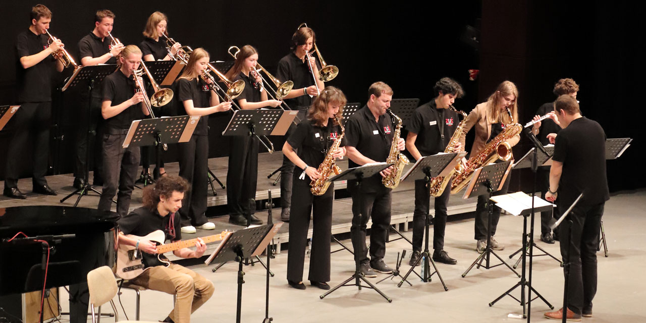 Ein Jazzorchester musiziert in einheitlicher schwarzer Kleidung
